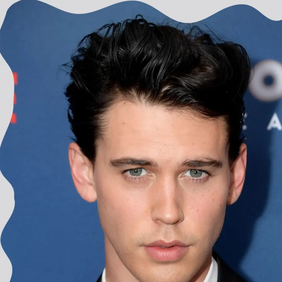 Quiff haircut side profile with faded sides and textured top.